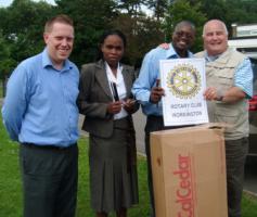 Past President Presents writing material to Kenyan School.